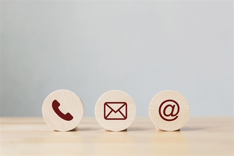 Wooden coins with symbol for telephone, email, address.